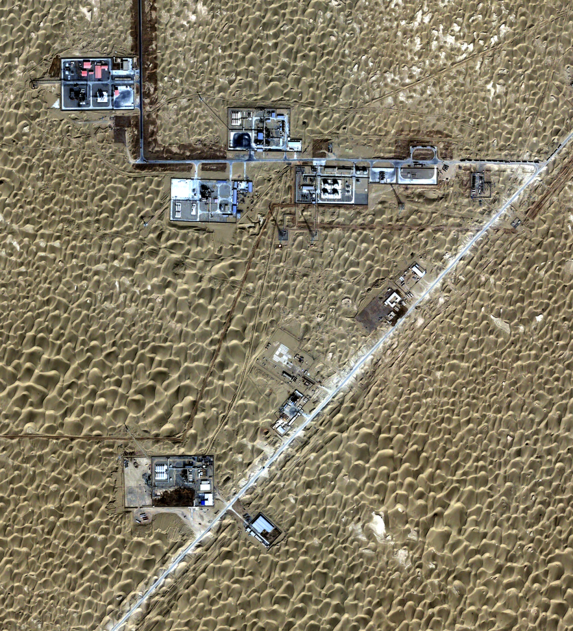 Satellite image of oil production facilities in a desert landscape in China.